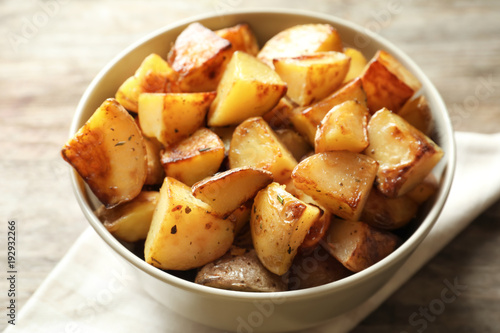 Tasty potato wedges in bowl, closeup