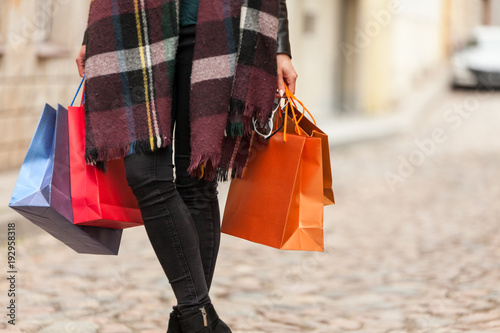 Girl holds many bags from shop