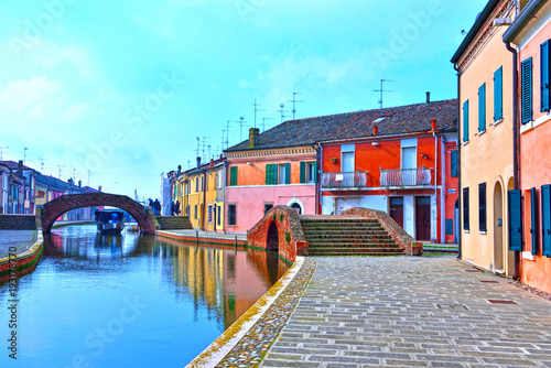 Small Italian town Comacchio also known as "The Little Venice", Emilia Romagna region, province of Ferrara, Italy: Colored houses in traditional architectural style