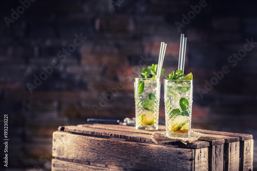 Mojito. Alcoholic cocktail drink mojito on wooden board in pub or sestaurant