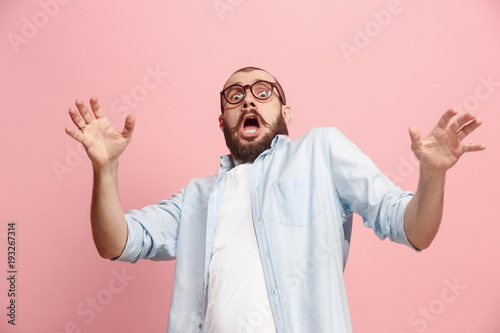 Portrait of the scared man on pink