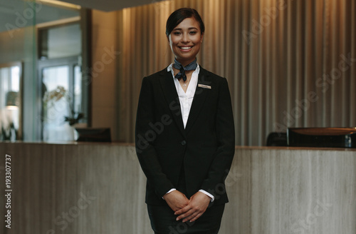 Beautiful concierge waiting for welcoming guests