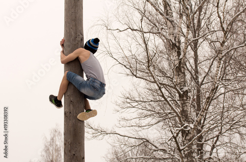 Festival. Boy climbs on a pole