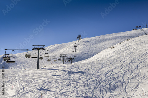 Chairlift at Italian ski area on snow covered Alps during the winter