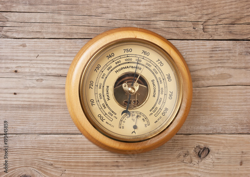 aneroid barometer on a wooden wall