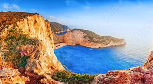 Greece. Epic sunset scenery of Zate island, full name is Zakynthos - popular summer resort and European travel destination in Greece. Picturesque Navagio beach panorama with shipwreck landmark.
