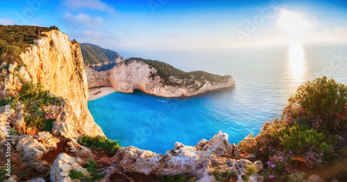  Greece. Epic sunset scenery of Zate island, full name is Zakynthos - popular summer resort and European travel destination in Greece. Picturesque Navagio beach panorama with shipwreck landmark. 