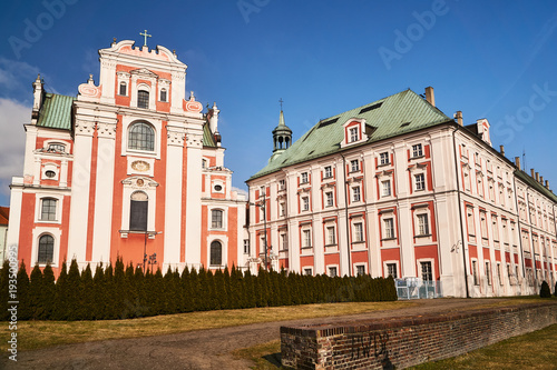  facade and belfry of baroque Catholic Church in Poznan.
