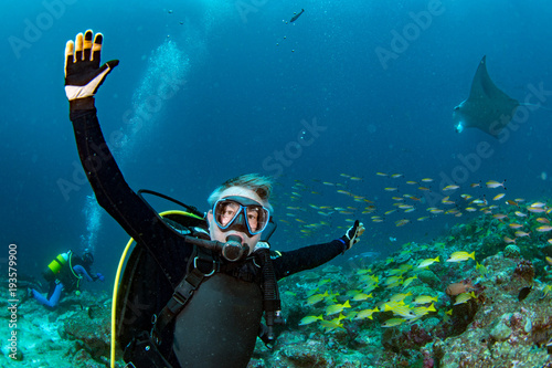 scuba diver and Manta in the blue ocean background portrait