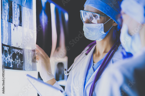 Two female women medical doctors looking at x-rays in a hospital.