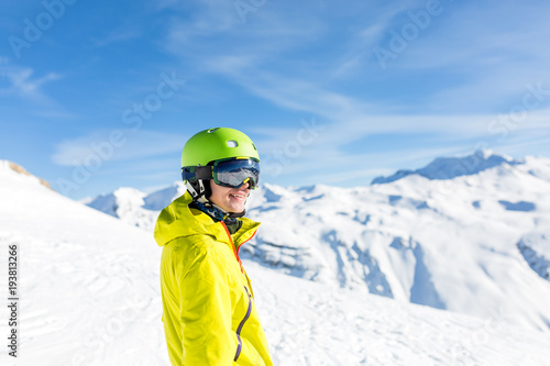 Photo of sports man wearing helmet on snowy slope
