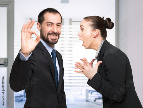 Man happy while a woman is shouting at him