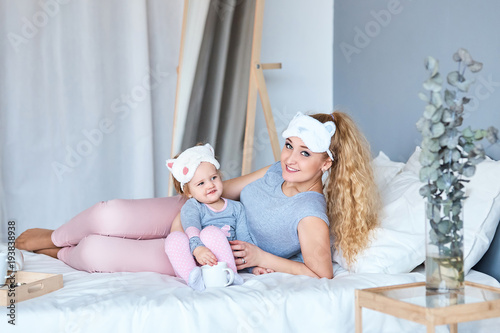 happy loving family. mother playing with her baby in the bedroom.