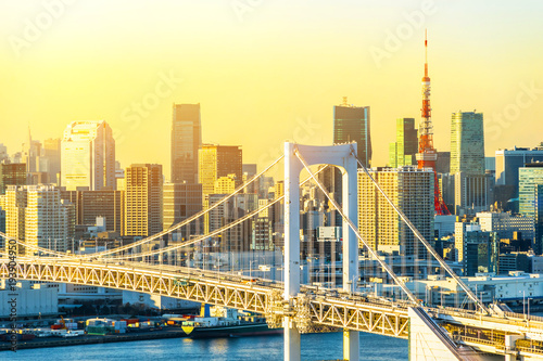 Asia Business concept for real estate and corporate construction - panoramic modern city skyline bird eye aerial view of Odaiba, tokyo tower & rainbow bridge under golden sun in Tokyo, Japan