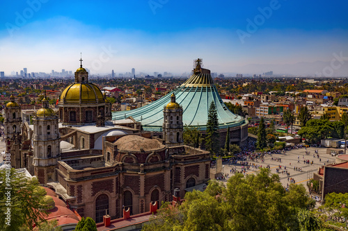 Mexico. Basilica of Our Lady of Guadalupe. The old and the new basilica, cityscape of Mexico City on the far