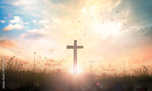 Easter Religious concept: The cross on meadow autumn sunrise background