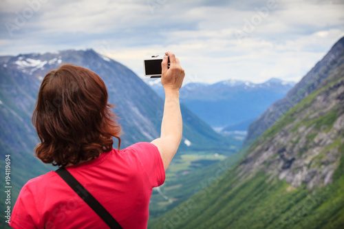 Tourist woman on Trollstigen viewpoint in Norway