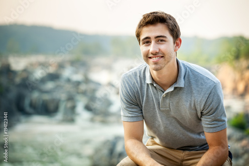 Young Man at a Waterfall Park