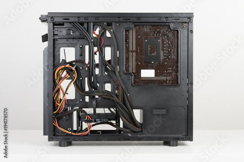 Building of PC, ATX motherboard and power supply unit inserted to tower case