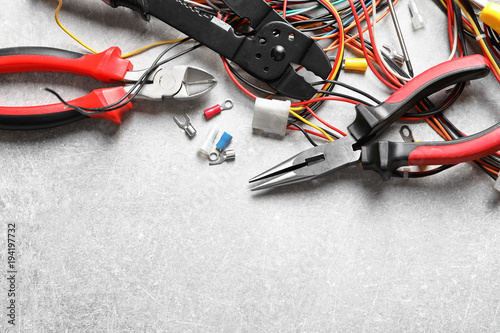 Different electrical tools on grey background