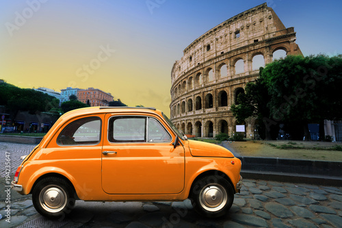 Retro car on background of Colosseum in Rome Italy