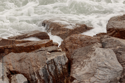 Waves breaking over rocks