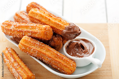 Churros with sugar and chocolate sauce . top view 