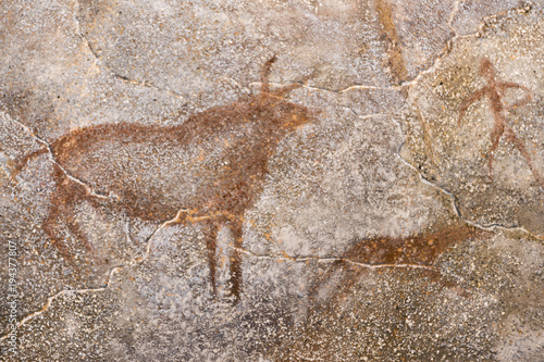 drawing of hunting for a mammoth on the wall of a cave. the stone age, ancient history. archeology.
