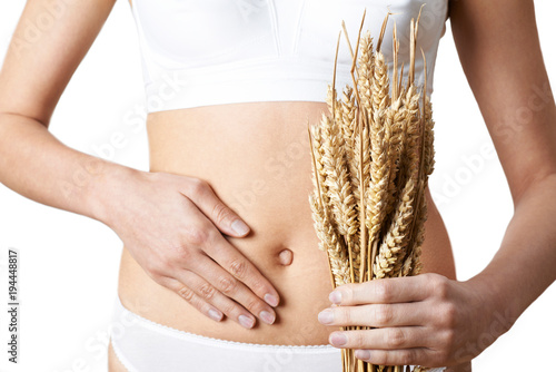 Close Up Of Woman Wearing Underwear Holding Bundle Of Wheat And Touching Stomach