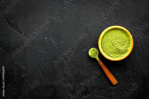 Japanese traditional product. Matcha green tea in bowl on black background top view copy space