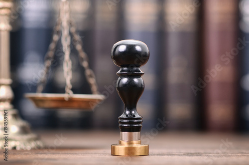 Notary seal and Scales of Justice on the wooden background, Notarized document concept, Legality concept.