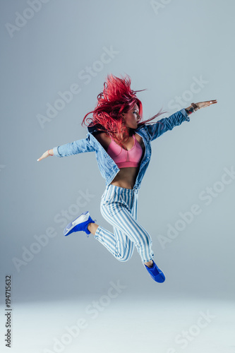 Young beautiful female dancer is posing in the studio