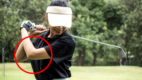 The principle of golf. Asian golf player, The arm is not straight.