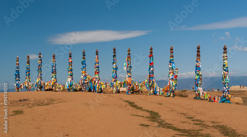 Sacred wooden columns with colourful ribbons, Baikal lake