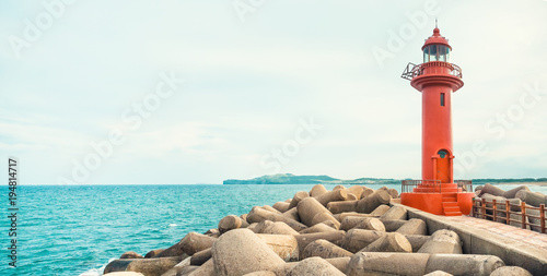 Panoramic view on red color lighthouse at Jeju Island - South Korea