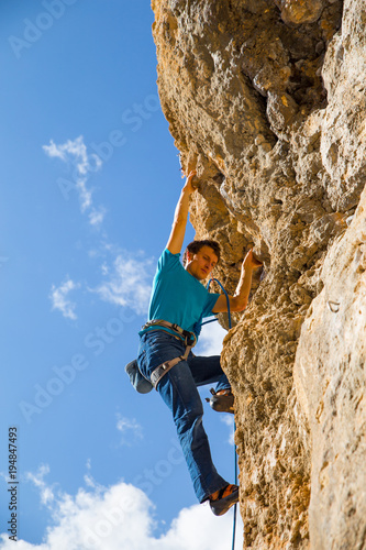 the rock-climber climbs difficult marshnut on the rock 