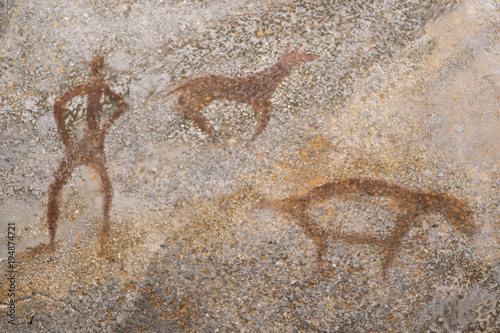 An image of an ancient man and animals on a cave wall. stone Age. history of antiquities.
