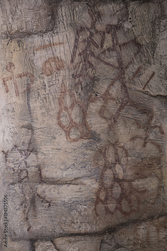 drawing of an ancient cave man on the wall of the cave ocher.