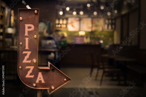 Pizza shop signboard, in front of the store . Retro style