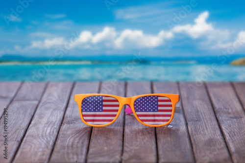 Sunglasses with american flag on wooden table