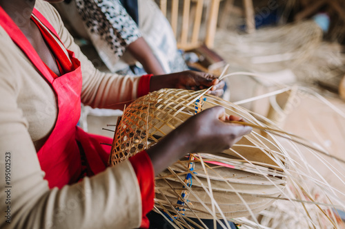 woman weaving basked out of bamboo in Rwanda Africa