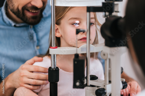 Dad with daughter in ophthalmology clinic