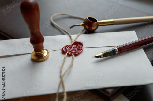 Fountain pen and old notarial wax seal on document, closeup