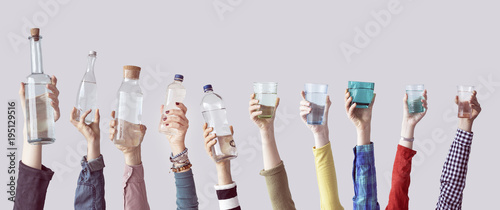 Different people holding water bottles and glass