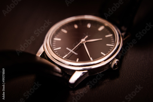 Quartz wristwatch with black dial close-up 