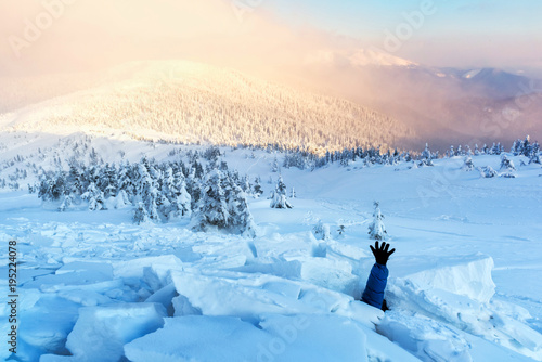 A man covered with a snow avalanche stretches out his hand to help. Danger extreme concept