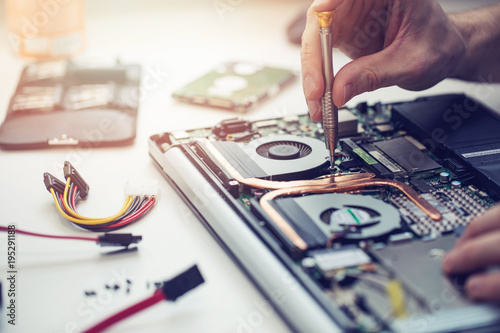 technician repairing laptop computer closeup