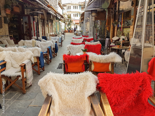 street coffee shop tables and chairs with warm cloth in Kalari street Ioannina city Greece