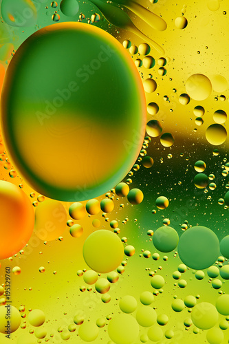 Mixing water and oil, beautiful color abstract background based on green and yellow circles, ovals, macro abstraction