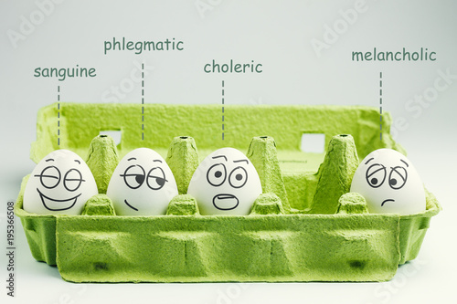 Four eggs in eggbox. Types of temperaments. Sanguine, choleric, phlegmatic and melancholic.